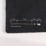A gold-toned chain earring with a clear faceted stone, shown on a dark slate background with measurement annotations indicating a total length of 52mm.