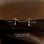 A small gold-toned chain choker accessory with two dangling teardrop charms is shown against a brown textured fabric background, with measurement labels indicating 12mm and 14mm widths and text noting 25mm net chain length and 2mm jump ring size.