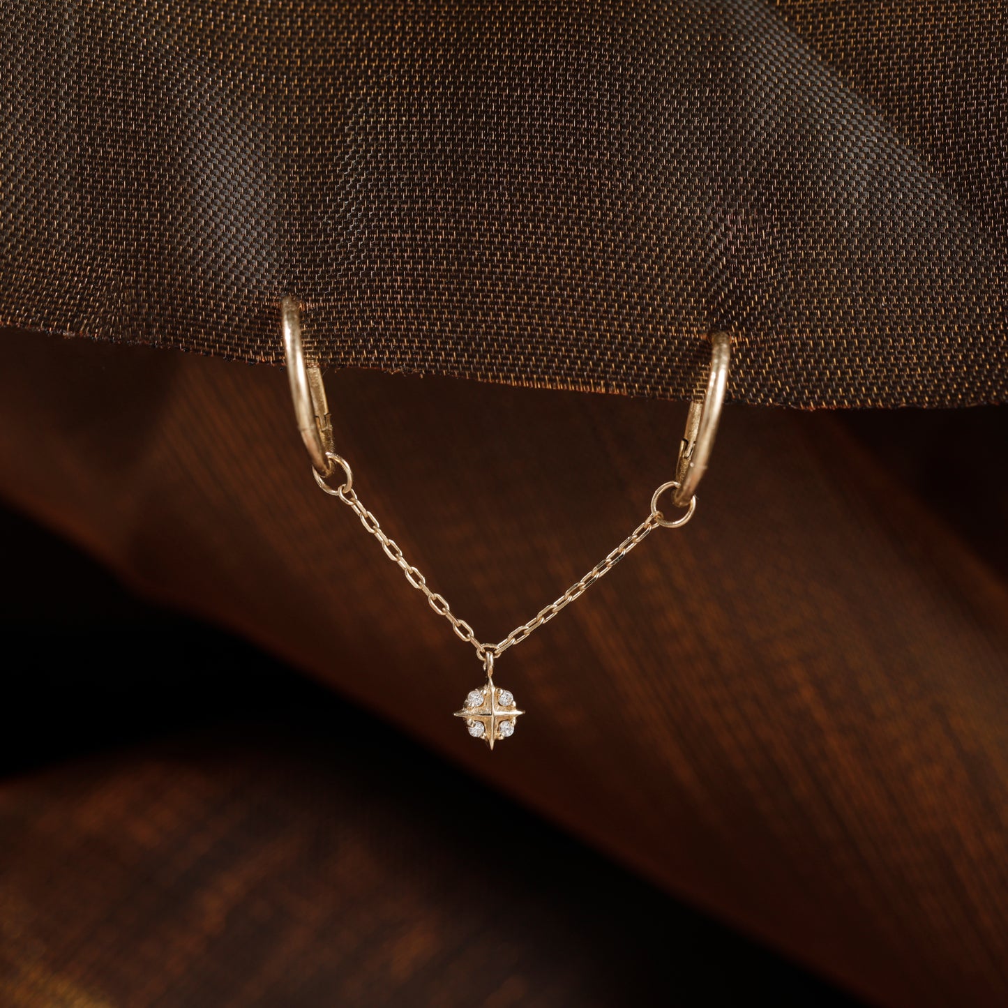 Gold-toned chain bar accessory with a small clear crystal charm, shown on a beige surface with overlaid dimension labels reading 30mm total, 2mm chain length, and 6*4mm crystal size.