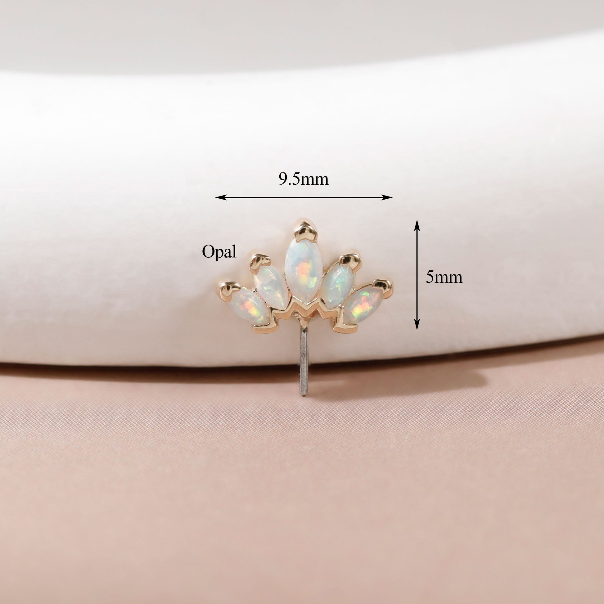 A small gold-toned stud earring with five iridescent opal stones arranged in a fan shape, shown on a soft beige surface with overlaid dimension arrows and labels reading 9.5mm and 5mm.